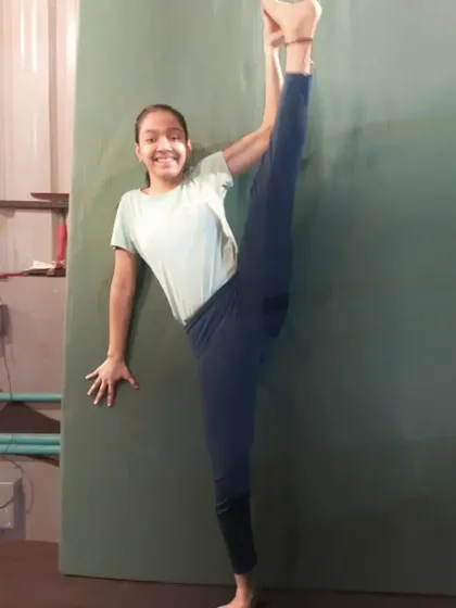 Flexibility is a huge part of gymnastics. This student is showing off her amazing standing split, a skill she developed through consistent stretching and practice in our flexibility training sessions.