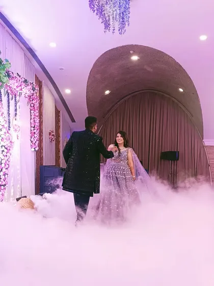 The couple's grand entrance through a cloud of smoke. I help plan these cinematic moments to make the engagement ceremony feel like a fairytale.