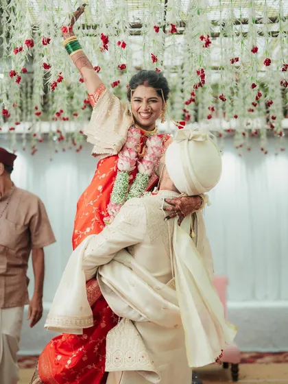A moment of pure celebration as the groom lifts his bride.