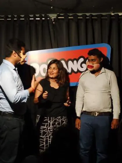 Sometimes one human puppet isn't enough. Here I am directing a scene with two volunteers on stage, creating a chaotic and funny dialogue.