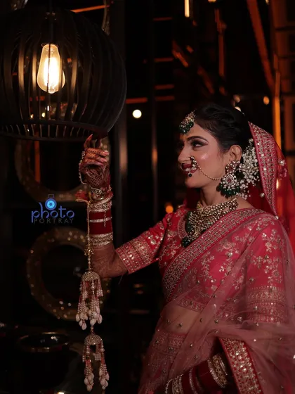 A candid-style bridal portrait using ambient light. This shot captures the bride in a natural pose, interacting with the decor of the venue.