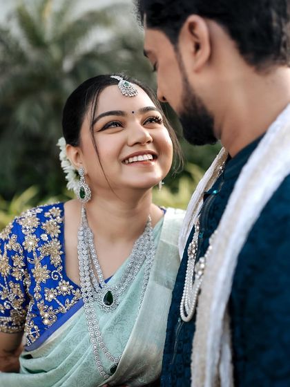 A beautiful close-up of the bride looking at her partner. Her eyes are full of love, and her makeup is perfectly done to enhance her expressive features.