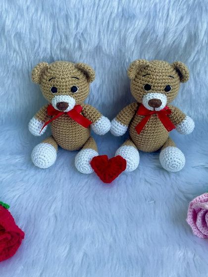 A classic teddy bear, a timeless gift for any age. This one is shown with a red ribbon, a black tie for 'Daddy Bear', and with expressive green eyes. They are soft, cuddly, and made to be loved.