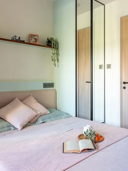 In this compact Mumbai bedroom, we used full-length mirrored wardrobe doors to create the illusion of spaciousness and reflect light.