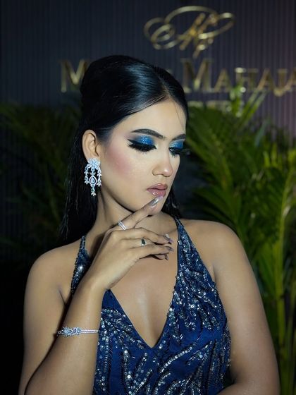 A serene shot with closed eyes, showcasing the beautiful blend of the blue smokey eye.