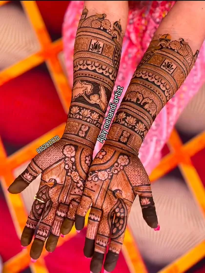 A close-up of a stunning bridal mehndi design featuring palace scenes and rows of lotus flowers and elephants. The detail in this Rajasthani henna art is what makes it so special.