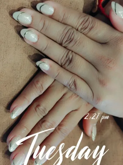 A subtle and modern update to the classic look. These milky white nails feature a delicate, thin silver line just below the tip for a touch of metallic shine.