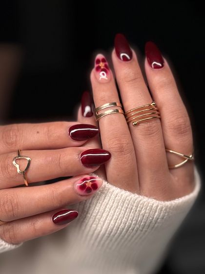 The full view of the burgundy and floral accent nail set. It's a perfect look for autumn or any time you want a touch of romantic elegance.