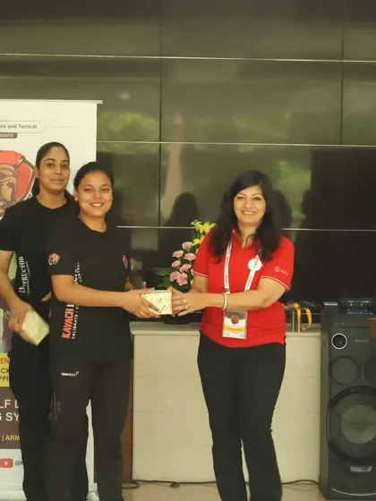 A female Kavach instructor receiving a token of appreciation at the ANON event.