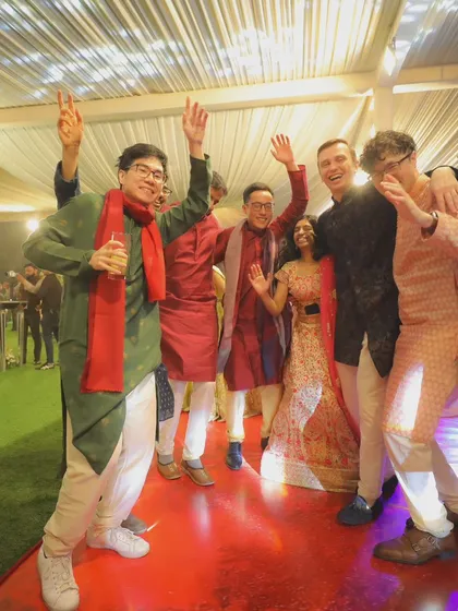 Friends and family celebrating on the dance floor. This high-energy group shot captures the fun and camaraderie of the wedding party.