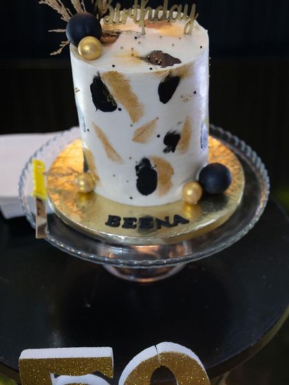 Another look at this stylish 50th birthday cake. The personalized "Beena" nameplate and abstract design made it a unique and sophisticated centerpiece for the dessert table.