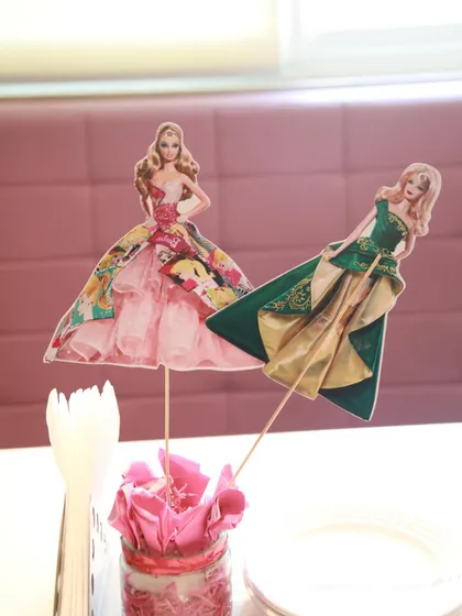 More examples of our custom Barbie-themed centerpiece decorations, showing different doll outfits.