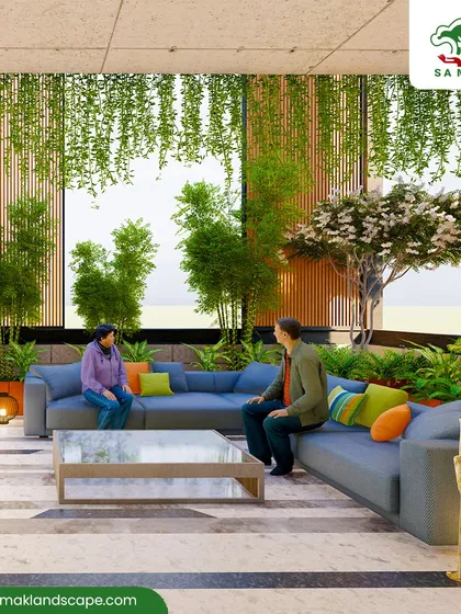 We transform large interior spaces, such as this corporate lobby, into vibrant atriums. The design uses multi-level planting with tall bamboo stalks, flowering trees, and cascading hanging plants to create a natural canopy over a central seating area, improving air quality and fostering a sense of tranquility.
