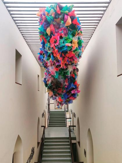An artwork is suspended in the central atrium of the CSMVS museum's staircase extension, which we completed in 1998. We design circulation spaces in cultural institutions to double as dramatic galleries for site-specific installations.