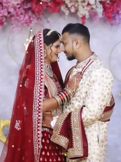 An intimate moment between the bride and groom. The soft lighting highlights the bride's flawless skin and shimmering makeup.