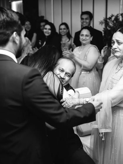 An emotional moment between the groom and a family member, captured in a heartfelt black and white photograph.