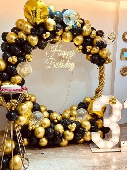 This black and gold themed 31st birthday is the definition of chic. We created a full circle balloon frame, added a custom neon "Happy Birthday" sign, and included large marquee numbers to create a glamorous photo-op for the celebration.