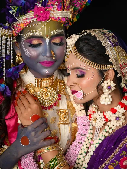 A close-up showing the detailed makeup on both Radha and Krishna.