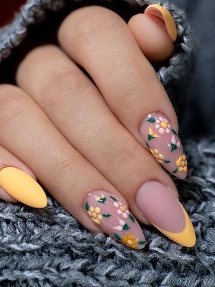 This detailed floral nail art is combined with a yellow French tip. I teach fine-line painting techniques to create intricate patterns like these flowers and leaves.