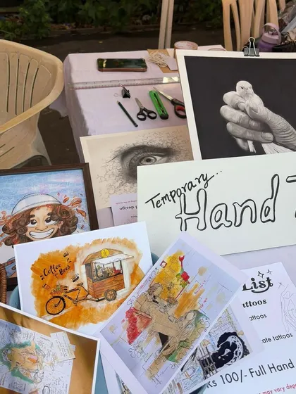 My setup at my first art stall. I had original sketches, prints, and even offered temporary hand tattoos. It was a great way to connect with people about my art.