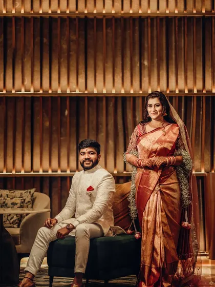 A lovely couple posing for a photo, with the bride draped in one of our beautiful floral shelas.