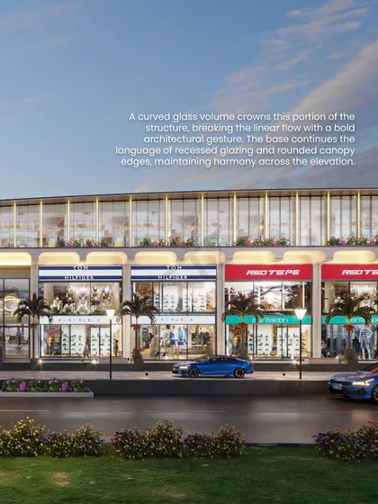 A curved glass volume crowns this portion of the structure, breaking the linear flow with a bold architectural statement.