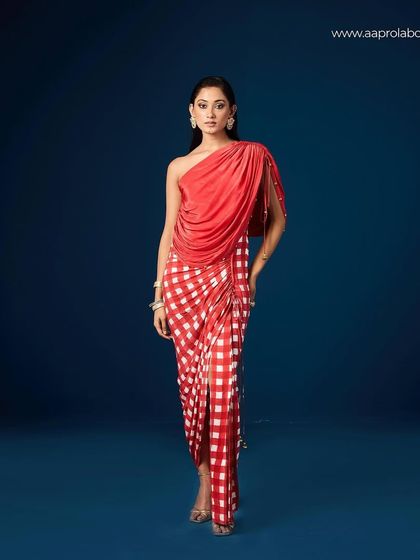 A full-length e-commerce style shot of the Aapro Seona Draped Dress against a solid blue background.