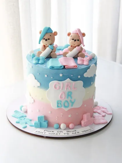 Pink or blue, we can't wait to see you! A classic gender reveal cake with blue and pink ombre, topped with two adorable teddy bears.