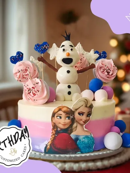 Let it go with this delightful Frozen-themed cake. It features Elsa, Anna, and a cheerful Olaf, surrounded by pastel-colored frosting, meringue pops, and edible snowballs for a cool celebration.