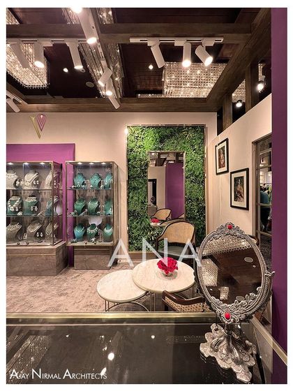 A private discussion nook within the Villandi '22 stall, featuring a green wall and an ornate mirror. This space was designed to provide a comfortable and focused environment for making purchase decisions.