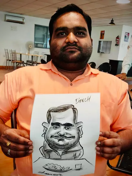 This guest proudly holds his caricature, a fun and witty celebration of his personality.
