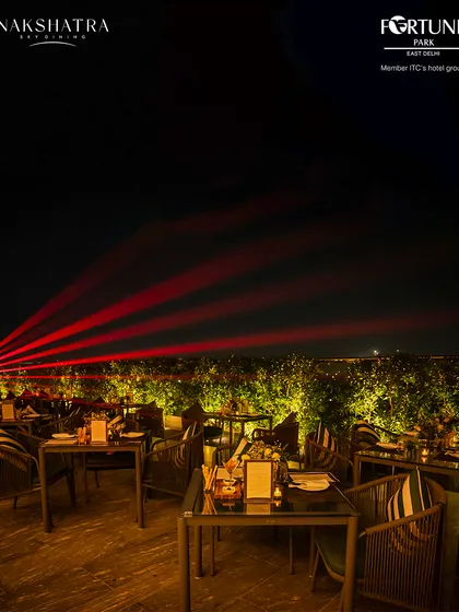 Laser lights cut across the night sky at Nakshatra, adding a dynamic visual element to our rooftop parties.