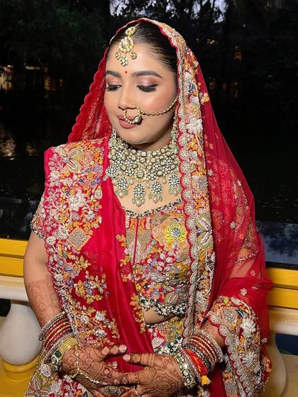 The bride with her dupatta, looking serene and beautiful. The makeup is soft, natural, and perfectly defined.