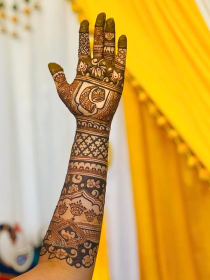 A close-up of a personalized wedding mehendi, featuring a Ganesha motif for blessings.
