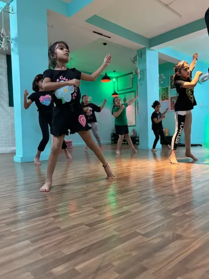 A dynamic shot of our young dancers in action. They learn to move with both individual flair and group awareness.