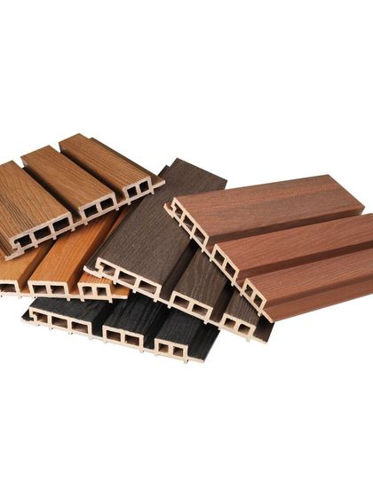 A pile of our WPC louver samples in various wood finishes, from light oak to dark walnut. These are durable and perfect for both indoor and outdoor use.