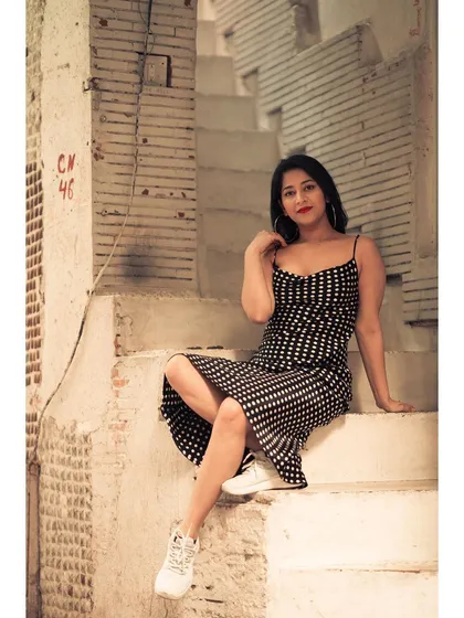 The old, weathered steps and walls of this location have so much character. It’s the perfect setting for a classic look with a modern twist, like this polka-dot dress with sneakers.