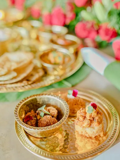 Even the side dishes are given special attention. Here, a small serving of a dry vegetable preparation and a sweet treat are plated elegantly on the side.