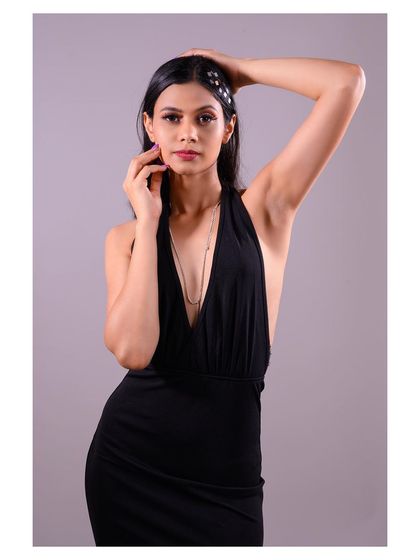 This pose, with the model's hands framing her face, adds a touch of classic glamour to the shot.