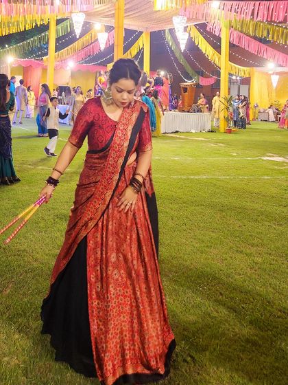 Captured in motion with dandiya sticks, this image shows a lehenga that's perfect for festive dancing.