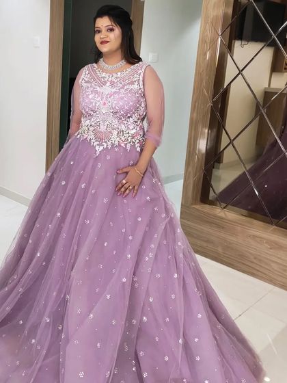 A final shot of the client in her stunning lavender gown, ready for her reception party.