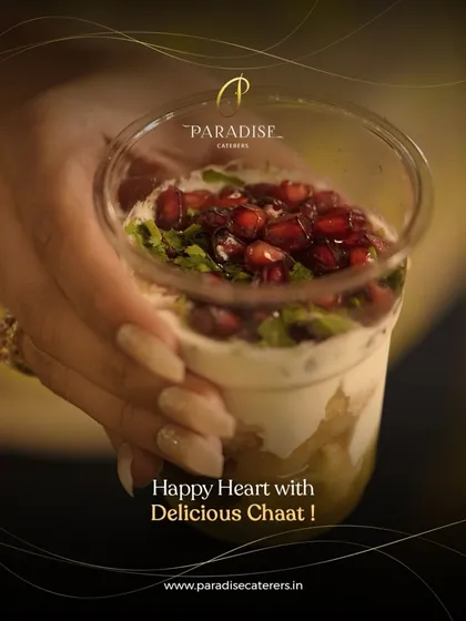 A happy heart with delicious chaat. This layered chaat in a cup, topped with pomegranate seeds, is a portable and delightful snack.