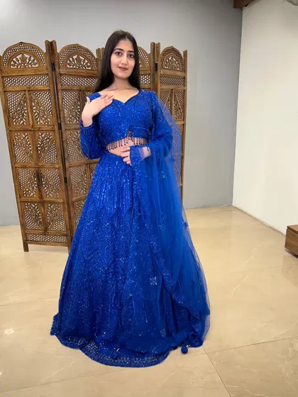 A full-length shot of the royal blue lehenga, showing its incredible sparkle and flattering silhouette.