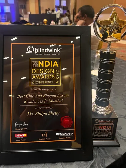 A close-up of the trophy and certificate for "Best Chic And Elegant Luxury Residences In Mumbai." Every award feels special and motivates us to keep pushing our creative boundaries.
