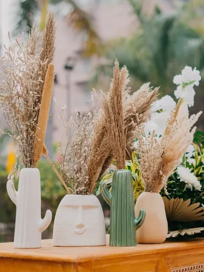 Unique vases and pampas grass arrangements that add a touch of modern, quirky style to the event.