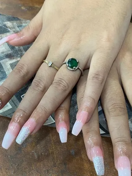 A soft and elegant look with a touch of sparkle. These long, square-shaped nail extensions feature a smooth pink-to-white ombré effect, with a silver glitter gradient on the tips for a dazzling finish.
