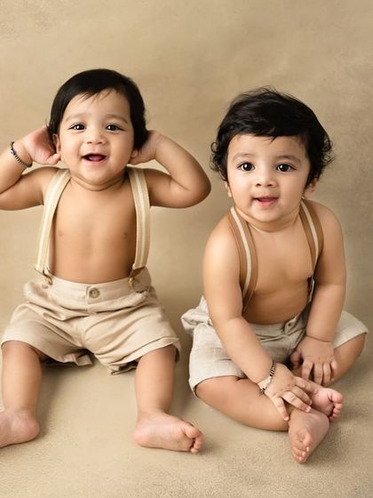 Double the smiles, double the fun. These ten-month-old twin brothers are full of playful energy, making their sitter session an absolute joy to photograph.