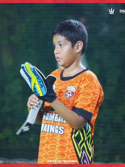 The last line of defense. A young goalkeeper getting ready for action, learning a crucial and specialized position.