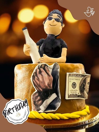 A cake for the man who celebrates in style. This design features a fondant figure with a champagne bottle, a luxury watch, and a hundred-dollar bill.