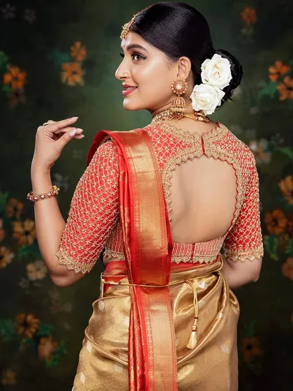 This red and gold Kanchivaram blouse features a beautiful cut-work back, a signature design element I love to incorporate. The hand embroidery uses zardosi, sequins, and beads for a truly divine bridal look.